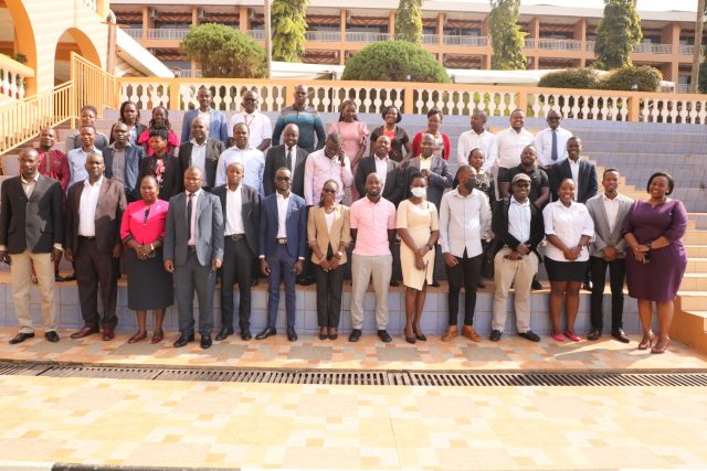 URSB Deputy Registrar General, Alex Anganya (2nd L) in a group picture with Tier IV Non Deposit Taking Institutions Representatives at Hotel Africana in Kampala.